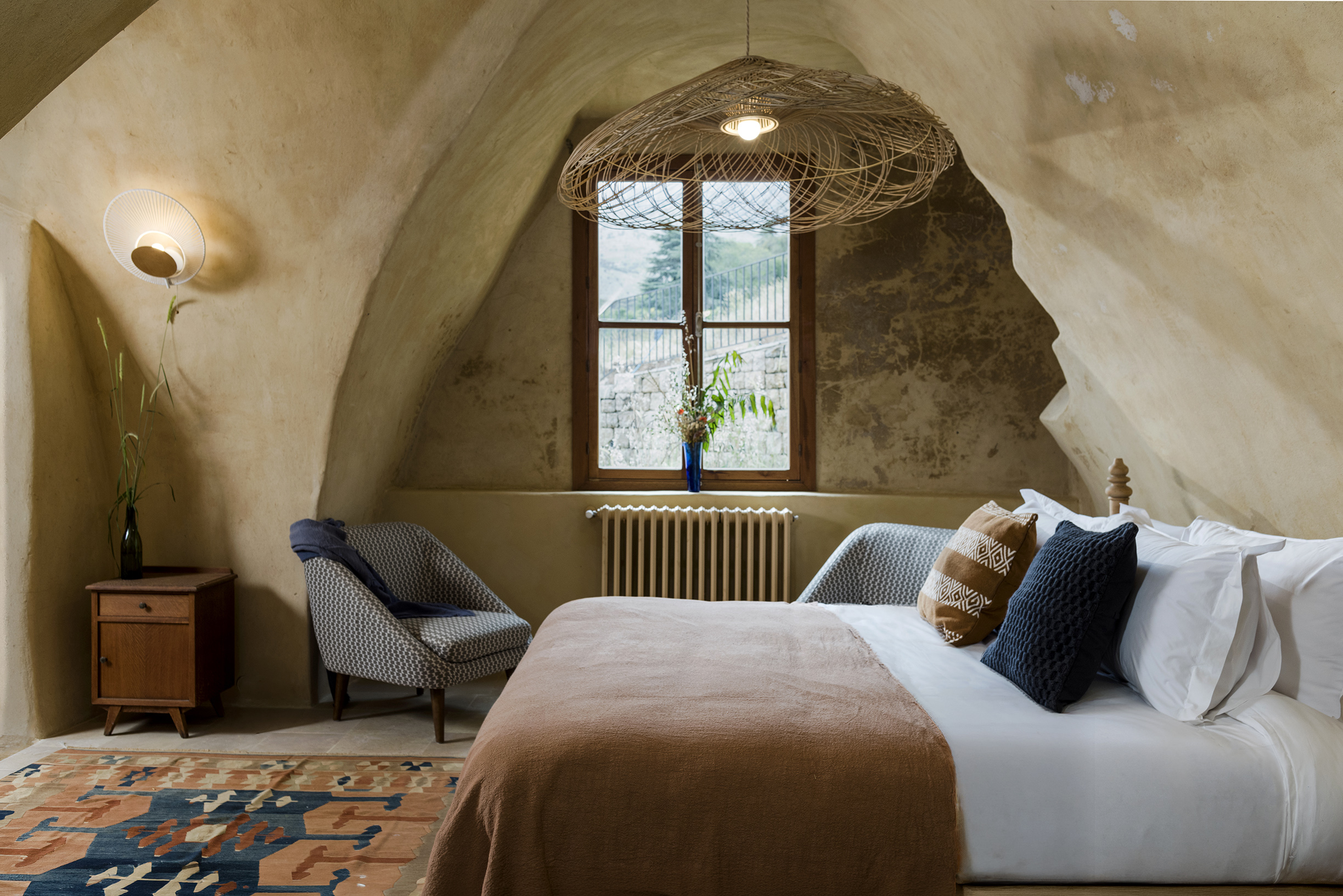 Interiors of a caved bedroom at Maison Des Sources Guesthouse